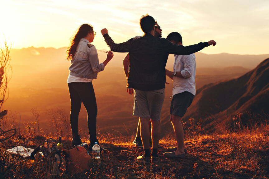 Group of people hiking at sunset
